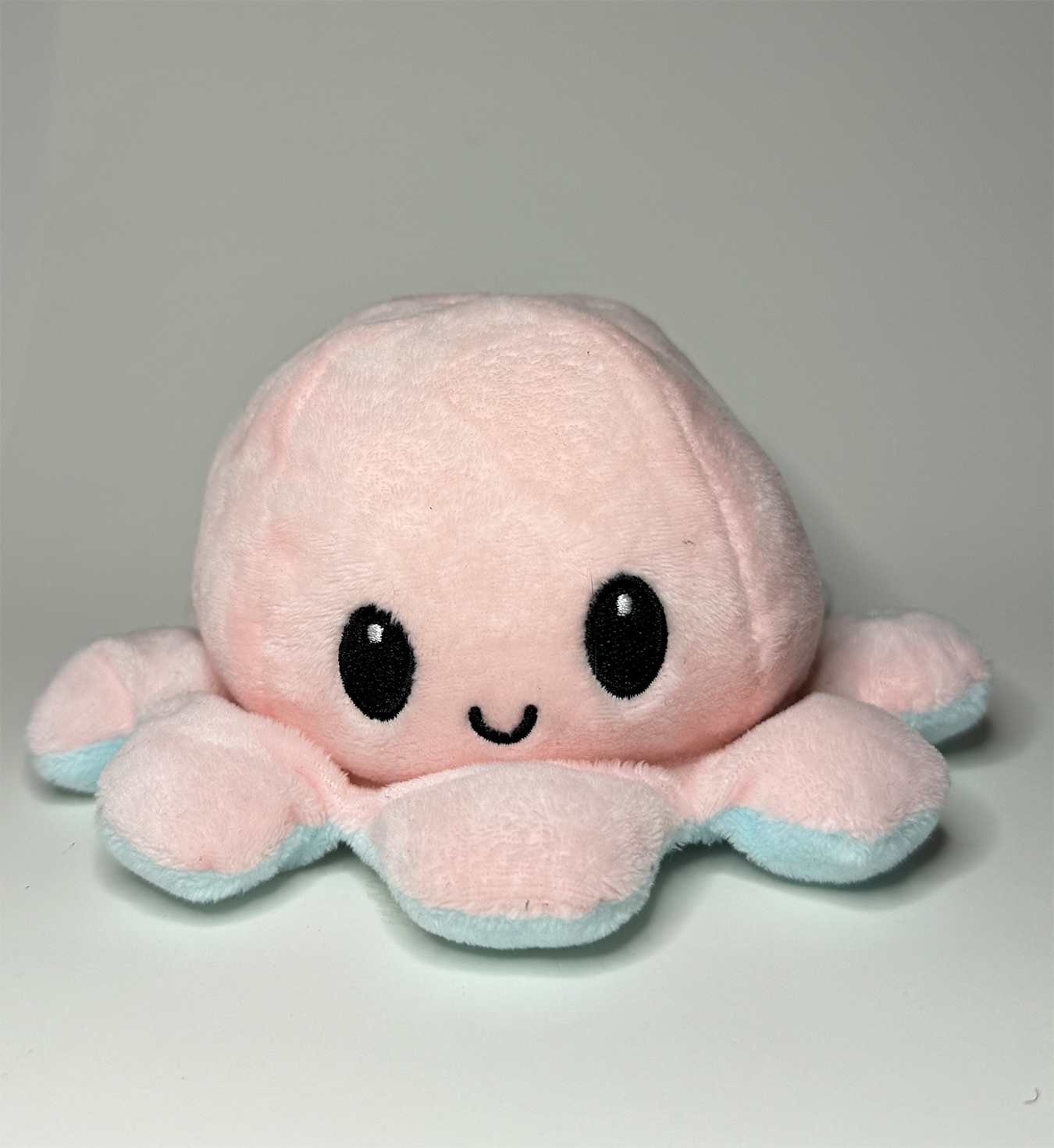 Image of smiling octopus plushie from front view
